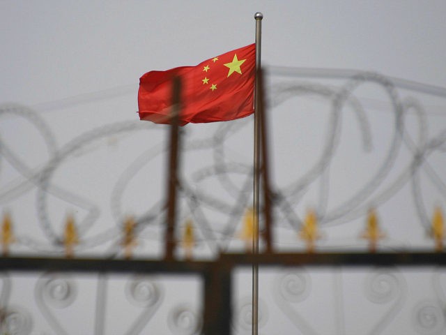 Chinese flag barbed wire housing compound Xinjiang China Uighur Getty 640x480