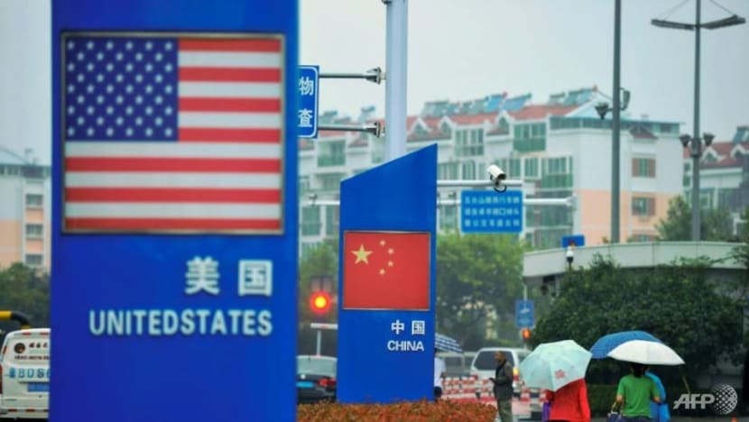 signs with the us and chinese flags hang outside a store selling foreign goods in qingdao in china s eastern shandong province a day after beijing announced an additional 60 billion in retaliatory tar 153776359
